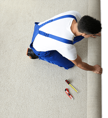 overhead view of carpet installer installing carpet