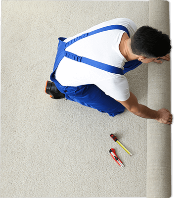 overhead view of carpet installer installing new carpet