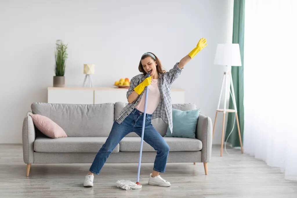 happy woman cleaning her new flooring