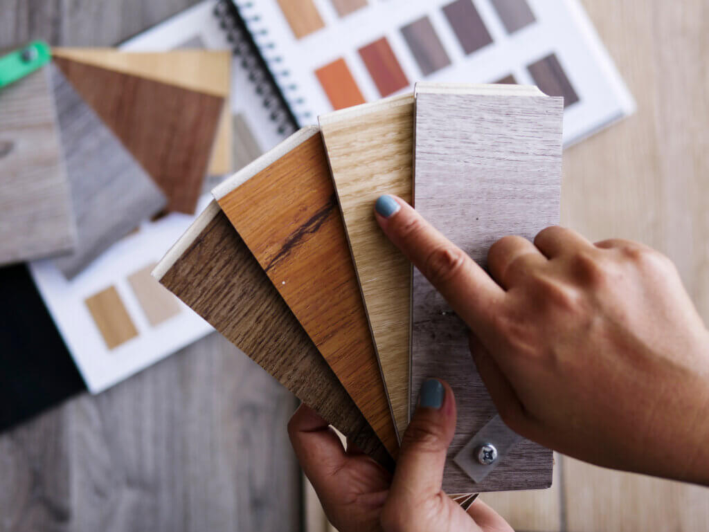 Flooring customer holding different color laminate samples