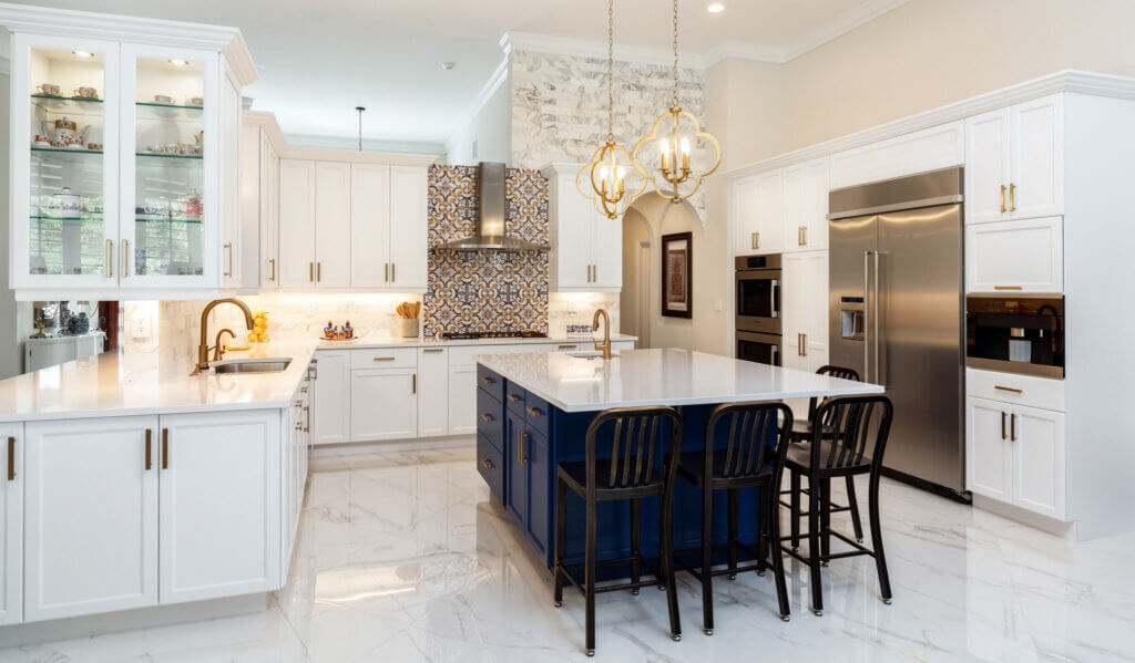 Beautiful luxury home kitchen with white cabinets and tile flooring